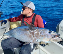 Load image into Gallery viewer, Casting Bucktail with BKK hooks Man holding large fish on a boat at sea.
