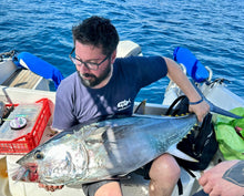 Load image into Gallery viewer, Casting Bucktail with BKK hooks Man holding a large tuna on a boat, showcasing the effectiveness of the Charydbis Blue Sardine 60g lure.
